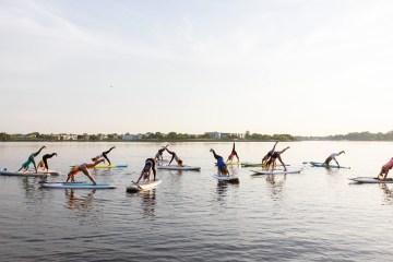 A group of People in a FloYo class in the nice sunny weather