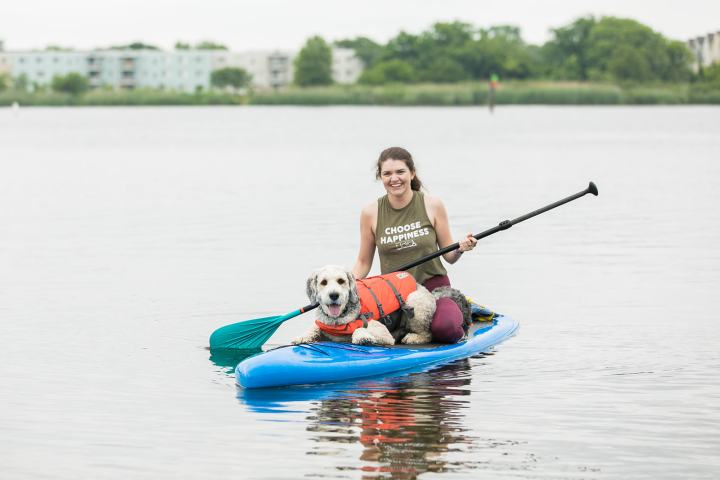 a small boat with a dog in a body of water