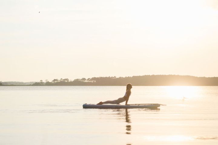 a person standing next to a body of water