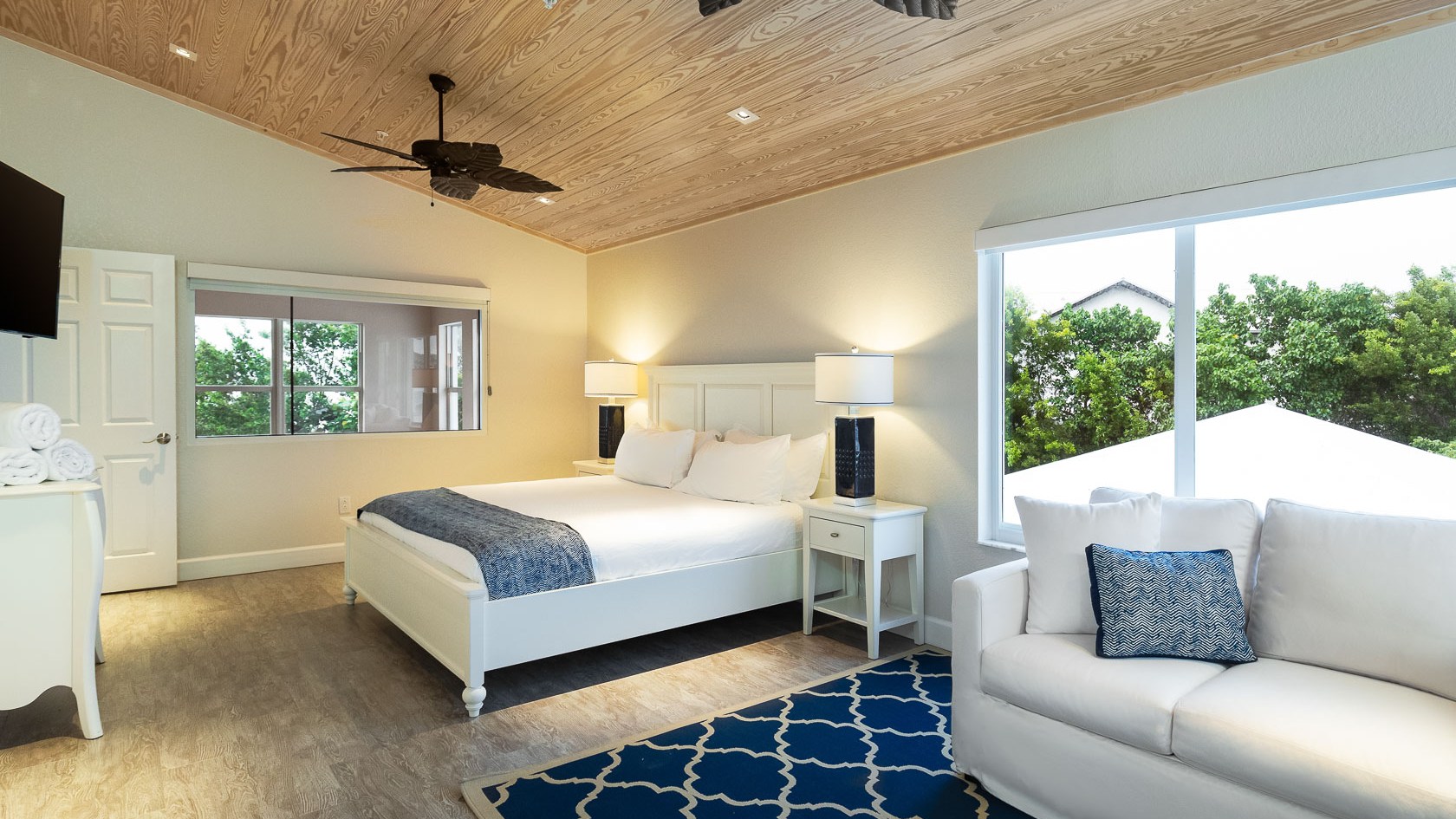 a living room filled with furniture and a bed