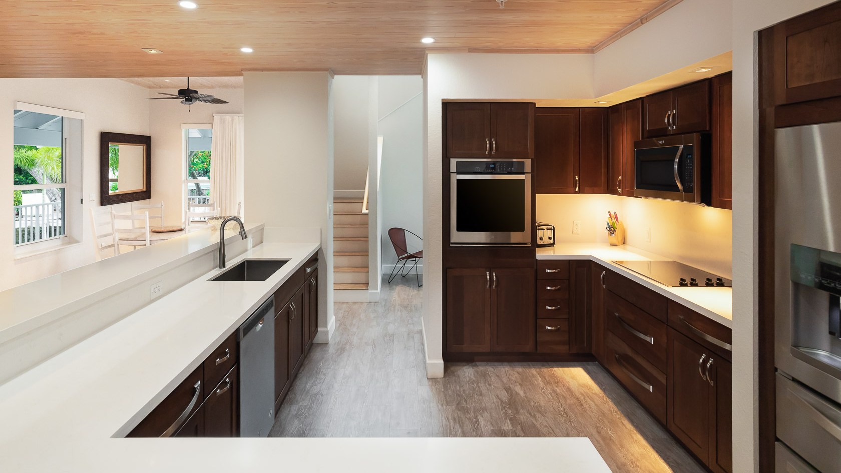 a modern kitchen with stainless steel appliances and wooden cabinets