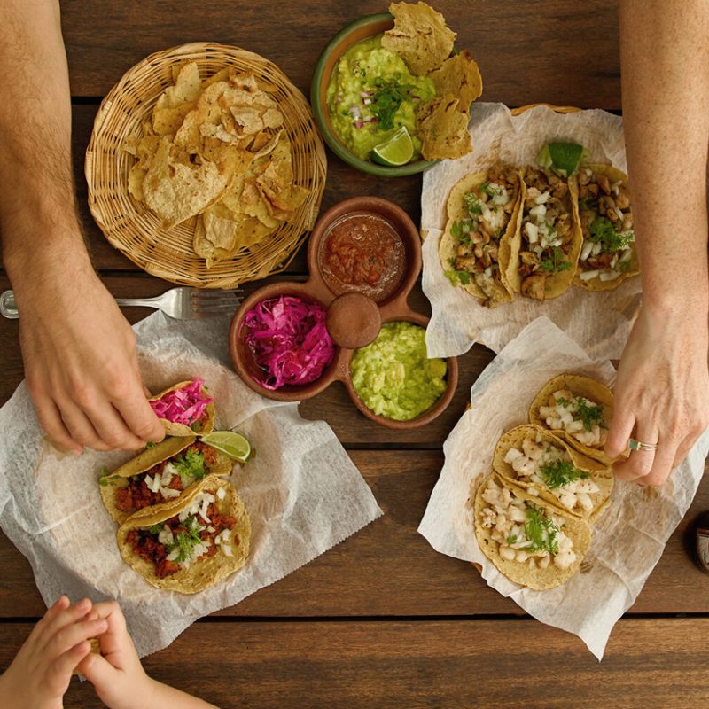 a person holding a hot dog