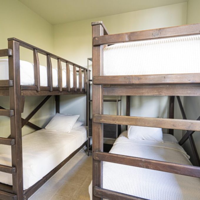 a bedroom with a bed and a chair in a room