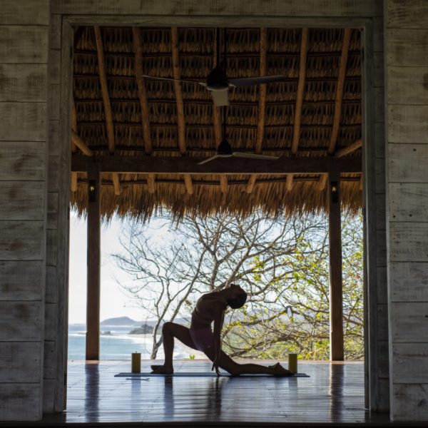 a person sitting at a table in front of a window