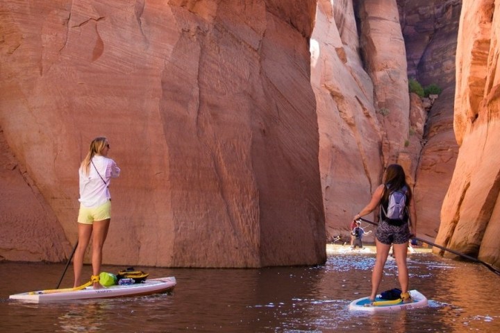 a couple of people that are standing in a canyon