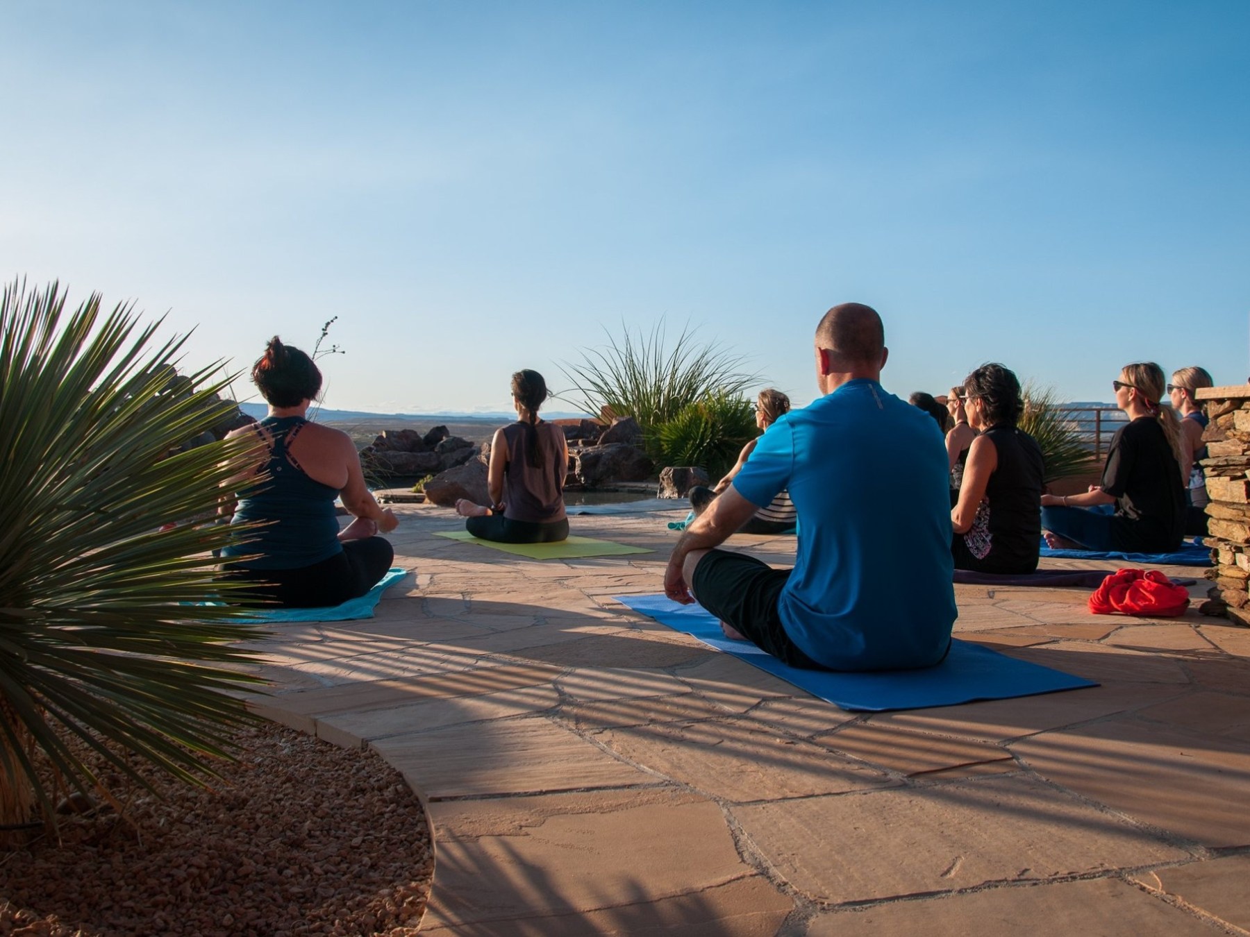 a group of people sitting at a beach