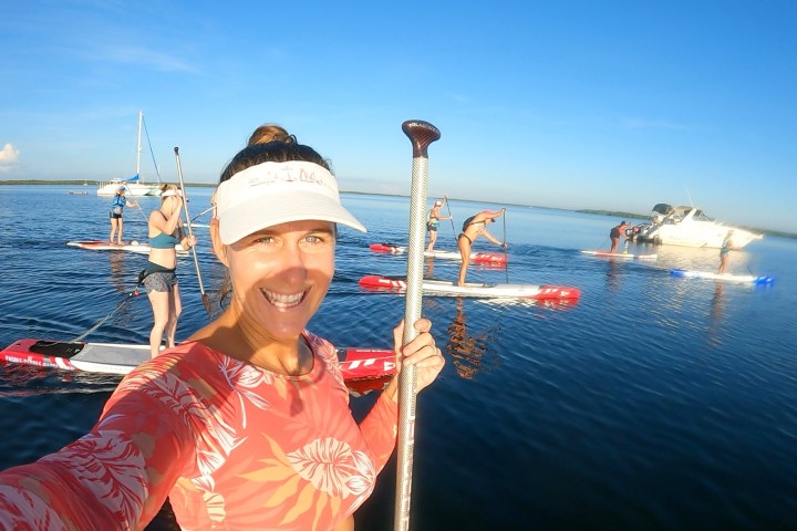 a woman standing next to a body of water