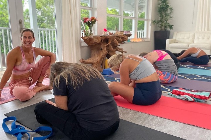a woman sitting next to a window