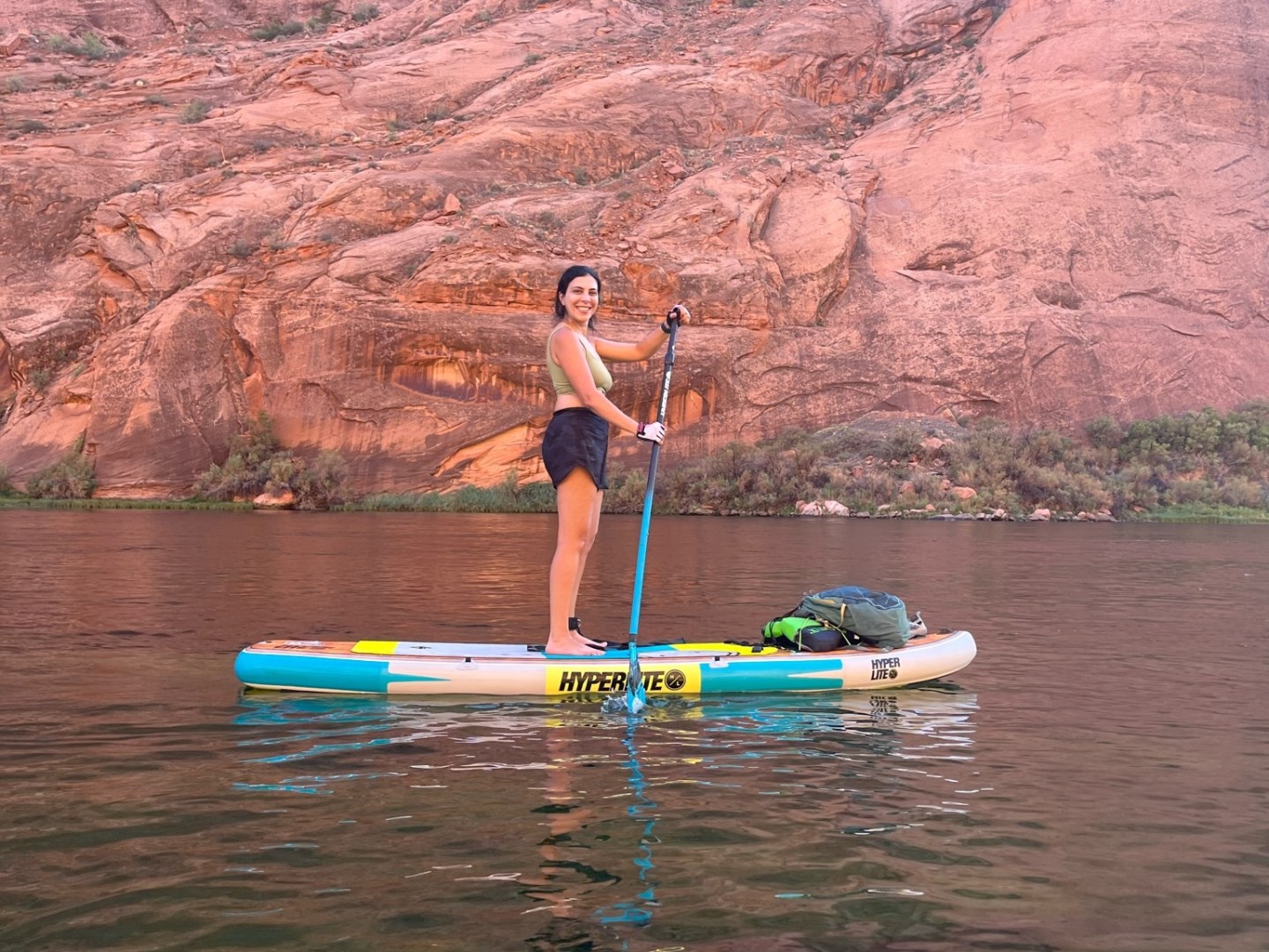 a man standing next to a body of water