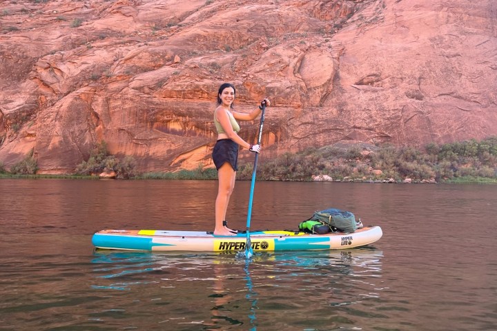 a man standing next to a body of water