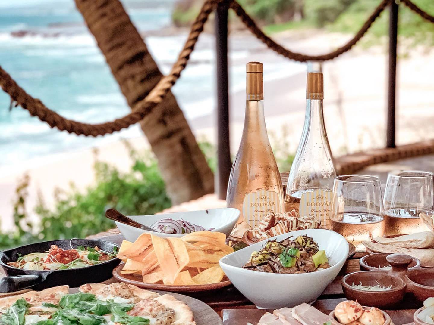 a plate of food with a slice of pizza on a table