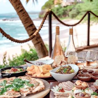 a plate of food with a slice of pizza on a table
