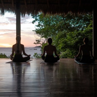a group of people sitting around a pond