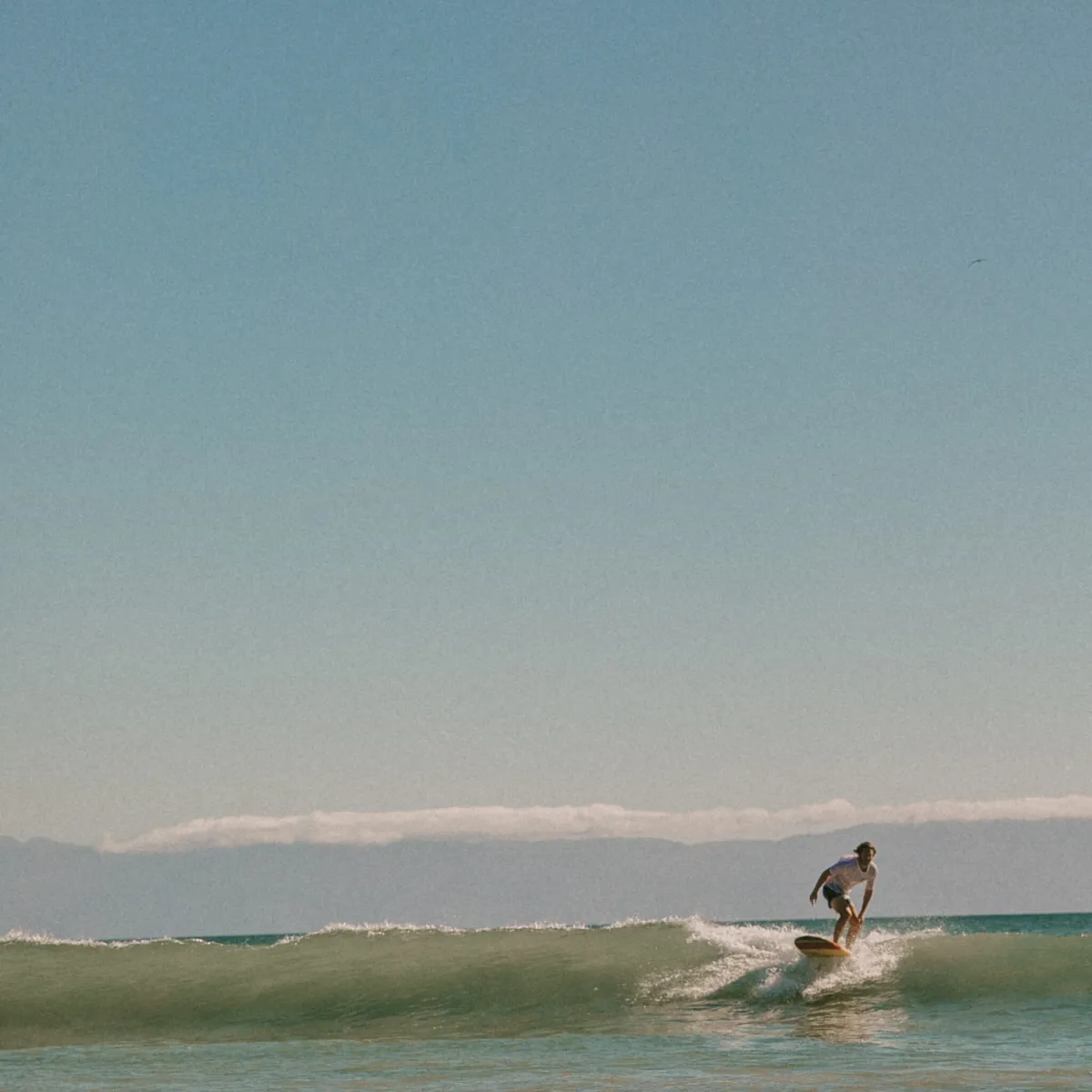 a man riding a wave on top of a body of water