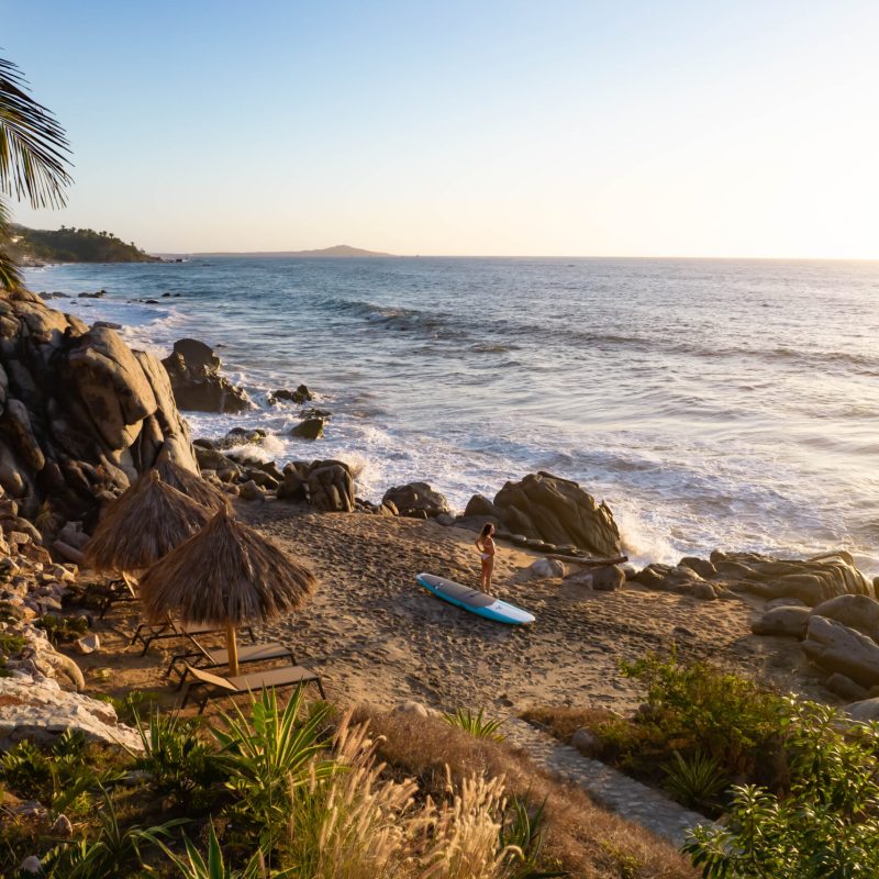 a rocky beach next to a body of water