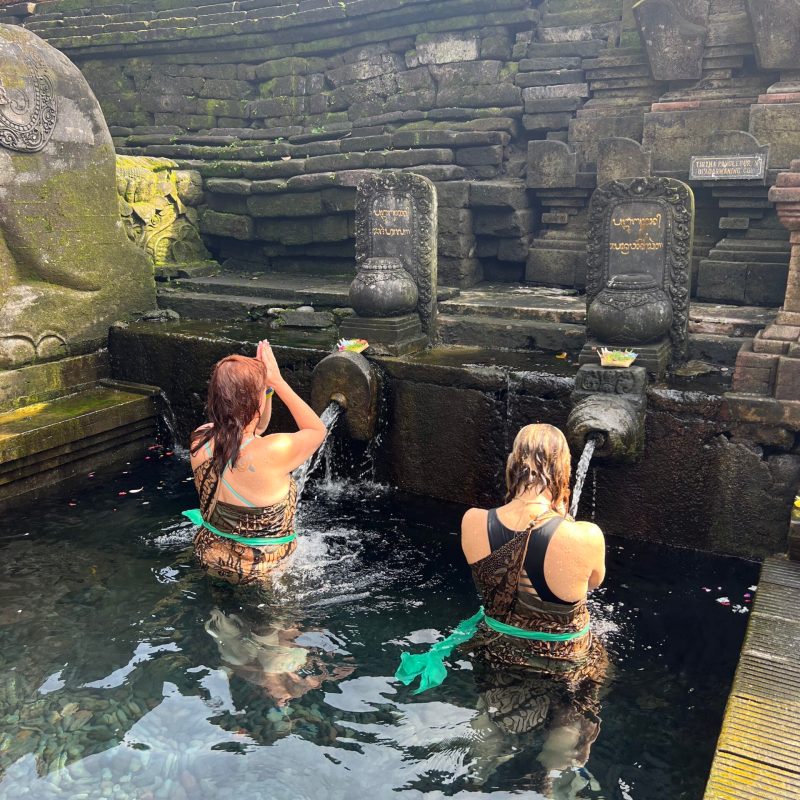 a group of people sitting on a rock