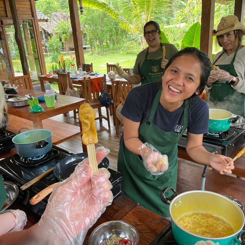 a group of people sitting at a table with food