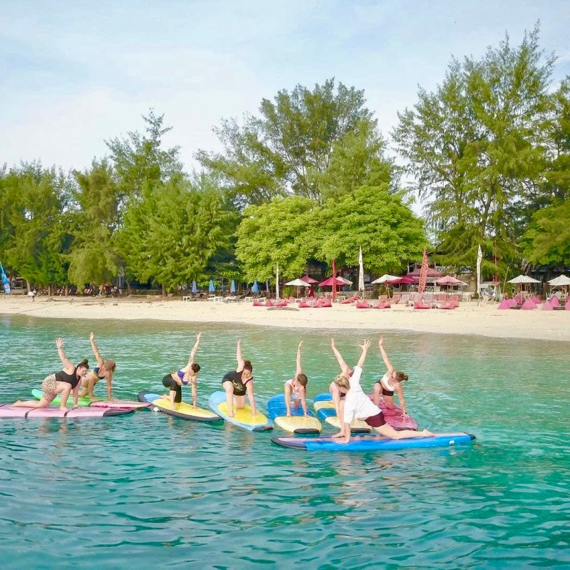 a group of people rowing a boat in the water