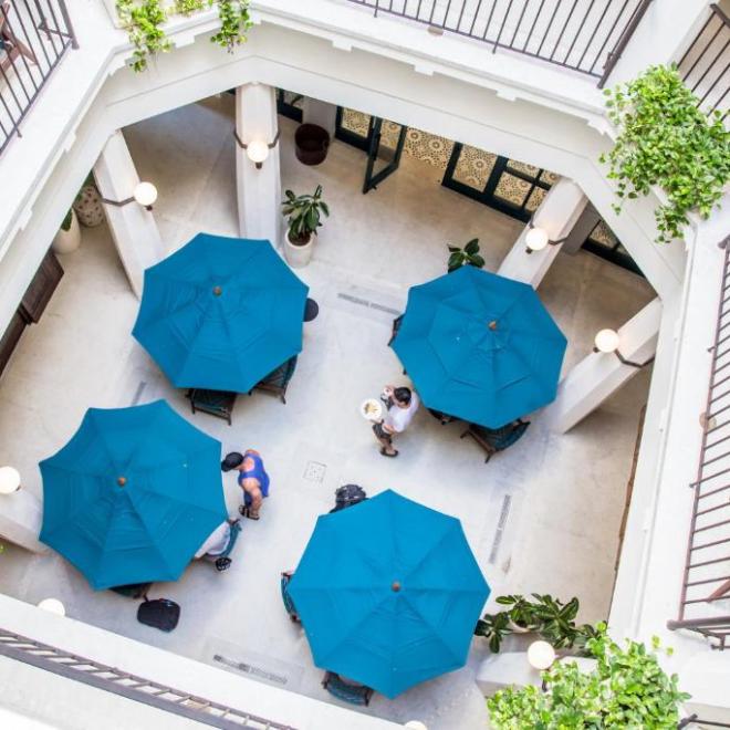 a bedroom with a vase of flowers on a table