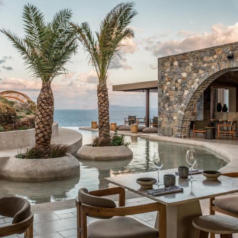 a group of people sitting at a table in front of a building