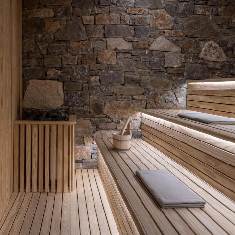 a wooden bench sitting in front of a brick building
