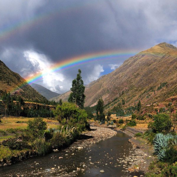 a waterfall with a mountain in the background