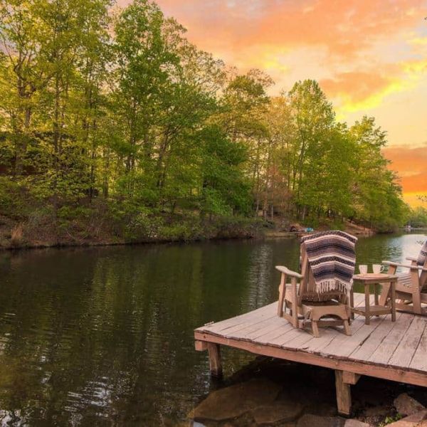 a wooden bench sitting next to a body of water