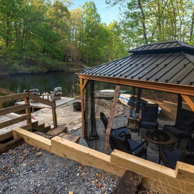 a wooden bench sitting next to a fence
