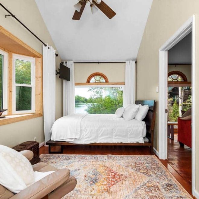 a bedroom with a large window