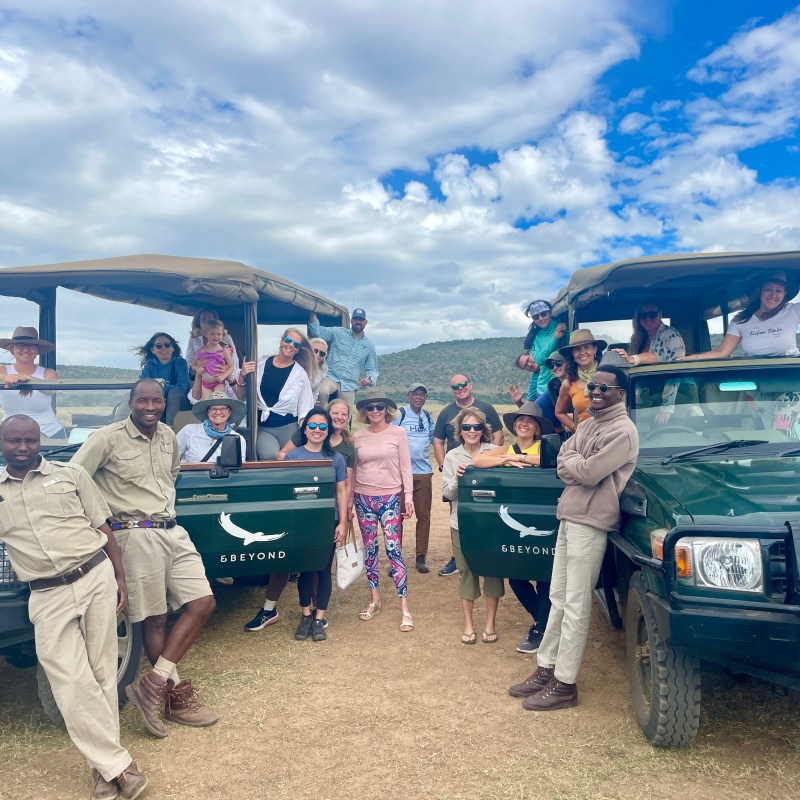 a group of people standing next to a truck