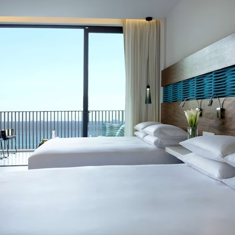 a bedroom with a bed and a large window