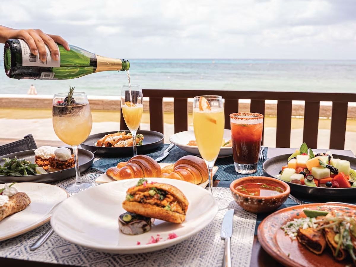 a group of people sitting at a table with a plate of food