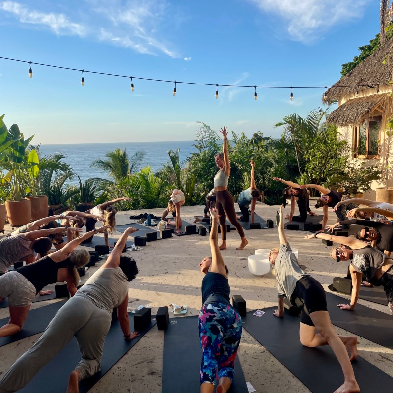 a group of people walking on a beach