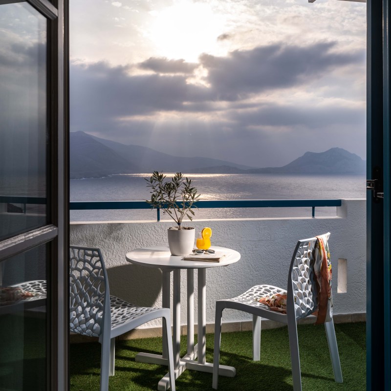 a chair sitting in front of a body of water