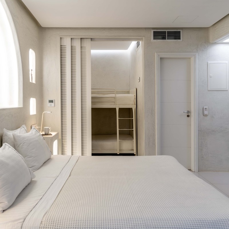 a hotel room with a bed and a mirror