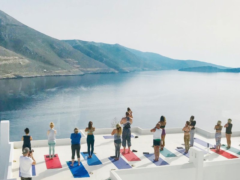 a group of people standing next to a body of water