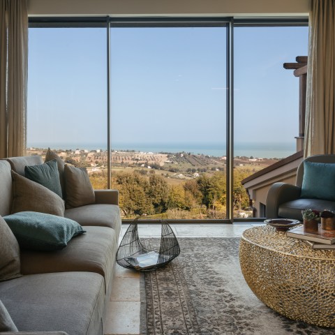 Cozy living room with a sea view through large windows.